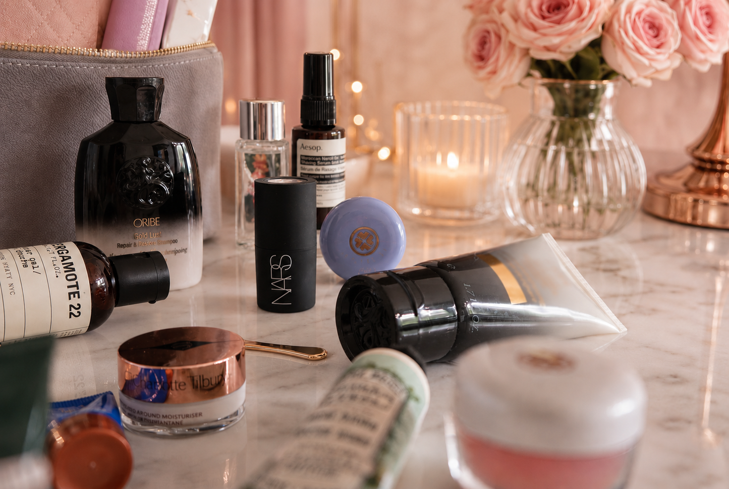 Luxury beauty and wellness travel essentials styled beside the TESS Diamond cosmetic bag in a warm hotel-inspired setting
